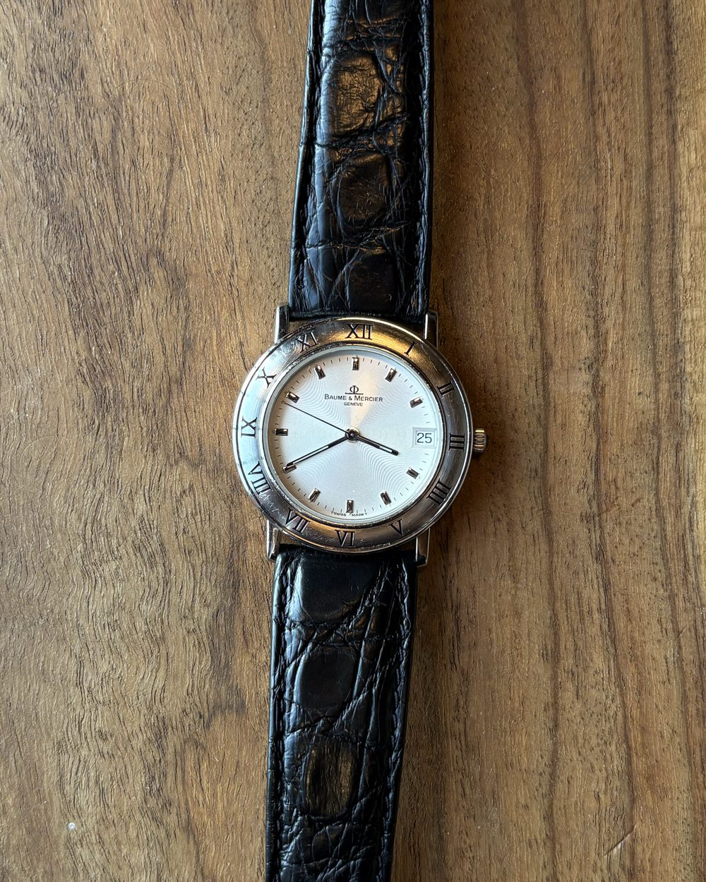 Baume & Mercier ref. MV045104 with coin-edge bezel, Roman numerals and silver dial on black strap